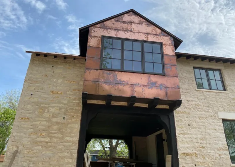 Copper metal panel facade on a stone building for Skylight Installation in Hernando